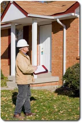 Inspector surveying a residence Picture of a home inspector